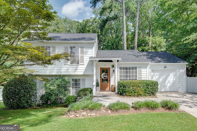 2716 Meadow Ridge Dr NW, Duluth, GA 30096 - tri-level home with a garage, concrete driveway, a front lawn, and roof with shingles