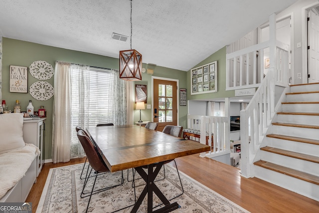 2716 Meadow Ridge Dr NW, Duluth, GA 30096 - dining room featuring wood finished floors, stairway, a textured ceiling, and vaulted ceiling