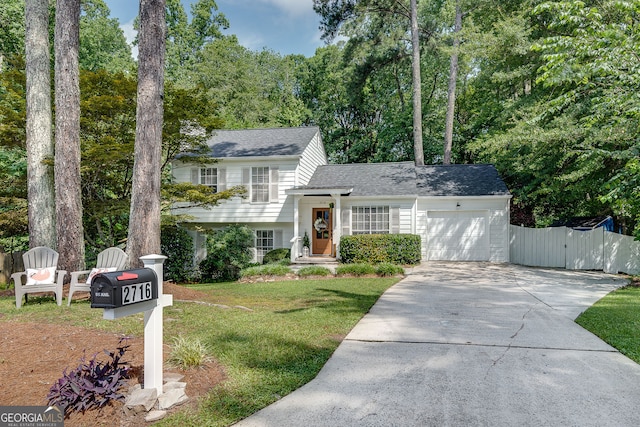 2716 Meadow Ridge Dr NW, Duluth, GA 30096 - tri-level home with driveway, an attached garage, a gate, and roof with shingles