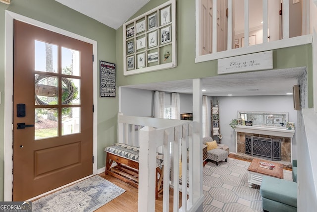 2716 Meadow Ridge Dr NW, Duluth, GA 30096 - entrance foyer with a stone fireplace and wood finished floors