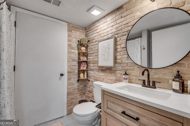 2716 Meadow Ridge Dr NW, Duluth, GA 30096 - full bath with brick wall, vanity, and tile patterned floors