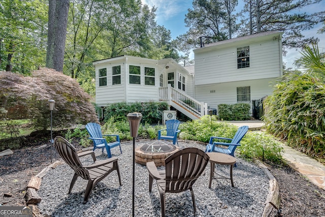 2716 Meadow Ridge Dr NW, Duluth, GA 30096 - back of house featuring a fire pit, stairs, and a patio