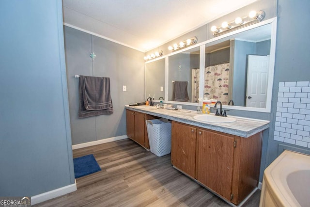 381 Jim Turner Rd, West Point, GA 31833 - full bath featuring double vanity, wood finished floors, and ornamental molding