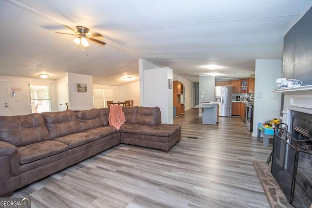 381 Jim Turner Rd, West Point, GA 31833 - living room featuring wood finished floors, a ceiling fan, and a fireplace with raised hearth