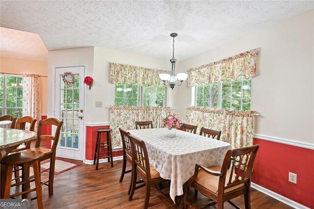 408 Victoria Place Dr, Locust Grove, GA 30248 - dining space featuring a chandelier, dark wood finished floors, and a textured ceiling