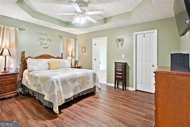 408 Victoria Place Dr, Locust Grove, GA 30248 - bedroom with a raised ceiling, dark wood finished floors, a textured ceiling, and a ceiling fan