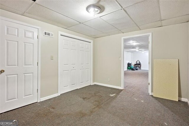 408 Victoria Place Dr, Locust Grove, GA 30248 - unfurnished bedroom featuring a drop ceiling, carpet floors, and a closet