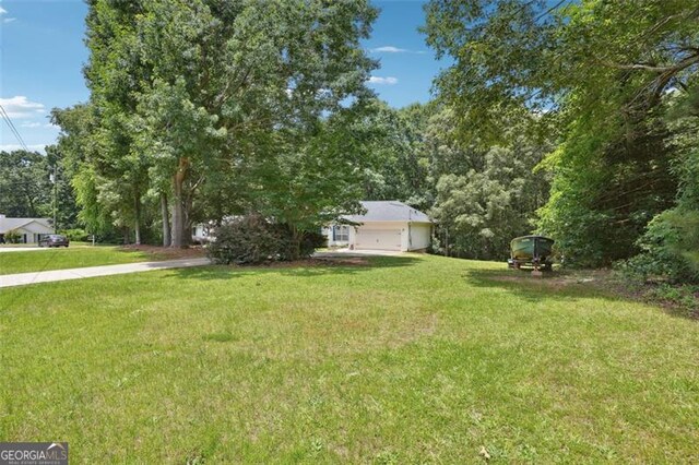 408 Victoria Place Dr, Locust Grove, GA 30248 - view of grassy yard featuring a garage