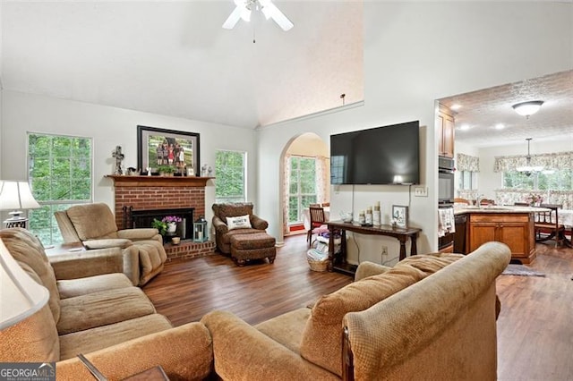 408 Victoria Place Dr, Locust Grove, GA 30248 - living room featuring arched walkways, wood finished floors, ceiling fan, a fireplace, and high vaulted ceiling