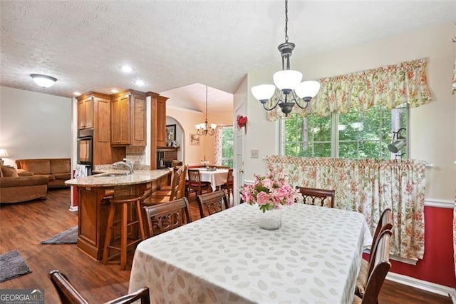 408 Victoria Place Dr, Locust Grove, GA 30248 - dining room with a chandelier, dark wood-type flooring, and a textured ceiling