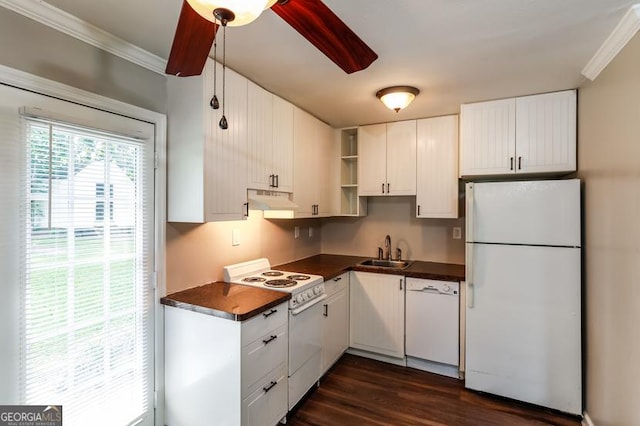 3993 Forrest Ct, Atlanta, GA 30341 - kitchen with white appliances, under cabinet range hood, dark countertops, crown molding, and dark wood finished floors