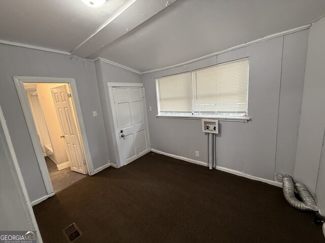 416 Middle St, Macon, GA 31201 - unfurnished bedroom with lofted ceiling and dark colored carpet