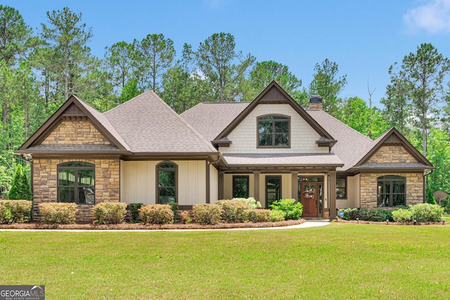35 Cornish Creek Ln, Covington, GA 30014 - craftsman-style house with a chimney, stone siding, a front lawn, and a shingled roof