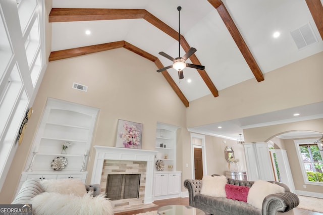 35 Cornish Creek Ln, Covington, GA 30014 - living area featuring high vaulted ceiling, built in features, a ceiling fan, beam ceiling, and arched walkways