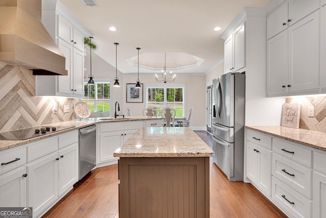 35 Cornish Creek Ln, Covington, GA 30014 - kitchen featuring appliances with stainless steel finishes, custom range hood, a raised ceiling, a chandelier, and decorative backsplash