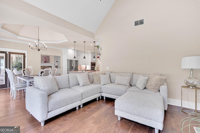 35 Cornish Creek Ln, Covington, GA 30014 - living room featuring a chandelier, dark wood finished floors, and a tray ceiling