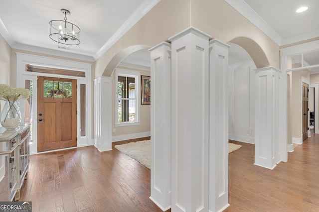 35 Cornish Creek Ln, Covington, GA 30014 - entryway featuring arched walkways, hardwood / wood-style flooring, crown molding, and a chandelier