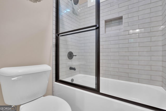 35 Cornish Creek Ln, Covington, GA 30014 - bathroom with toilet and bath / shower combo with glass door