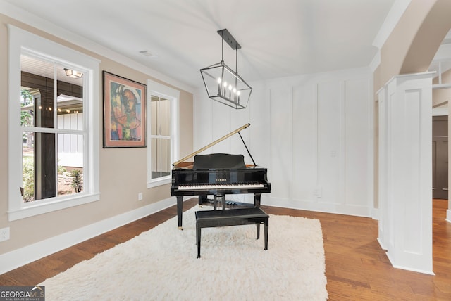 35 Cornish Creek Ln, Covington, GA 30014 - sitting room featuring wood finished floors, a decorative wall, arched walkways, and crown molding