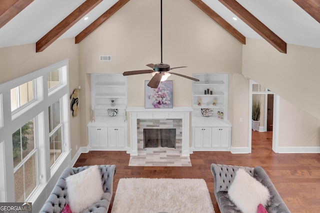 35 Cornish Creek Ln, Covington, GA 30014 - living area with high vaulted ceiling, wood finished floors, beam ceiling, ceiling fan, and a tile fireplace