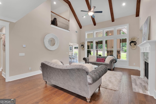 35 Cornish Creek Ln, Covington, GA 30014 - living area featuring ceiling fan, a fireplace, hardwood / wood-style floors, high vaulted ceiling, and beam ceiling