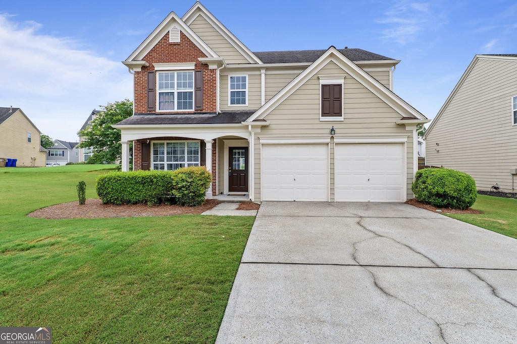 8970 Ruel Ln, Suwanee, GA 30024 - traditional-style house featuring driveway, brick siding, a front yard, and an attached garage