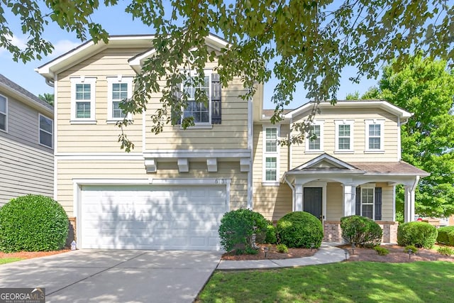 6131 Sparkling Cove Ln, Buford, GA 30518 - view of front facade featuring driveway, an attached garage, a front yard, and brick siding