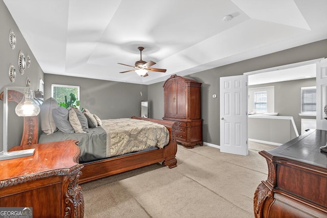 6131 Sparkling Cove Ln, Buford, GA 30518 - bedroom featuring light colored carpet, a tray ceiling, and ceiling fan