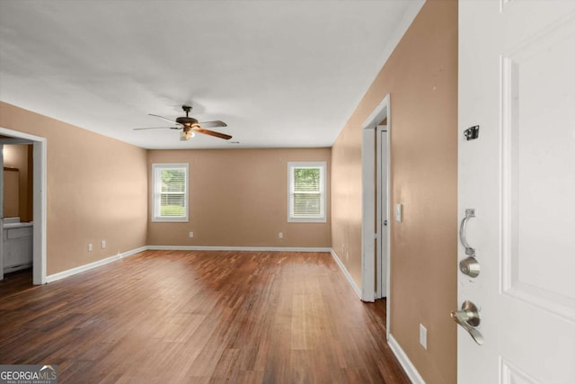 1799 Harmony Rd, Powder Springs, GA 30127 - unfurnished living room featuring a ceiling fan and dark wood finished floors