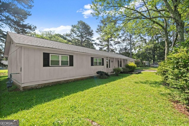 1799 Harmony Rd, Powder Springs, GA 30127 - rear view of house featuring a lawn and roof with shingles