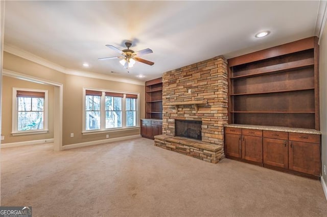 6186 Talmadge Run NW, Acworth, GA 30101 - unfurnished living room featuring a ceiling fan, healthy amount of natural light, built in features, light colored carpet, and ornamental molding