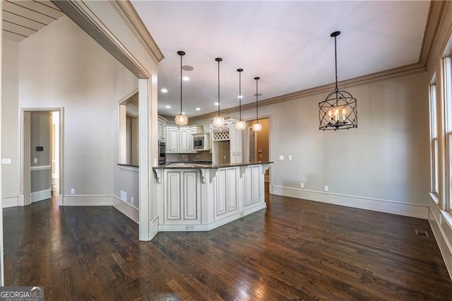 6186 Talmadge Run NW, Acworth, GA 30101 - kitchen featuring dark countertops, a kitchen breakfast bar, stainless steel appliances, dark wood-style flooring, and ornamental molding