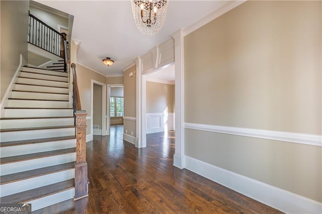 6186 Talmadge Run NW, Acworth, GA 30101 - foyer with a chandelier, dark wood-type flooring, stairway, and ornamental molding