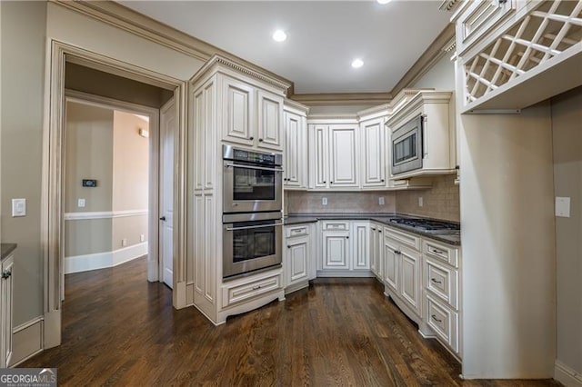 6186 Talmadge Run NW, Acworth, GA 30101 - kitchen featuring stainless steel appliances, dark countertops, backsplash, dark wood-style floors, and recessed lighting