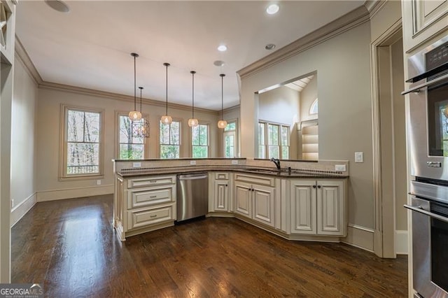 6186 Talmadge Run NW, Acworth, GA 30101 - kitchen with stainless steel dishwasher, cream cabinets, dark wood-style floors, crown molding, and hanging light fixtures