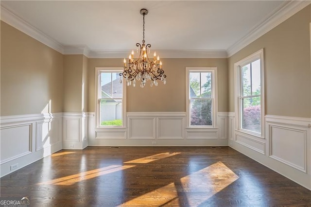 6186 Talmadge Run NW, Acworth, GA 30101 - unfurnished dining area with healthy amount of natural light, a chandelier, a wainscoted wall, wood finished floors, and crown molding