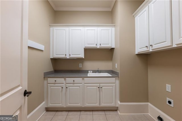 6186 Talmadge Run NW, Acworth, GA 30101 - washroom featuring hookup for an electric dryer, cabinet space, light tile patterned flooring, and ornamental molding