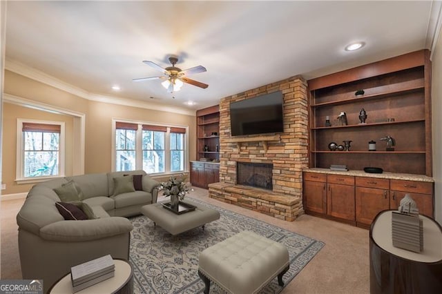 6186 Talmadge Run NW, Acworth, GA 30101 - living area with light colored carpet, a ceiling fan, a fireplace, built in features, and crown molding