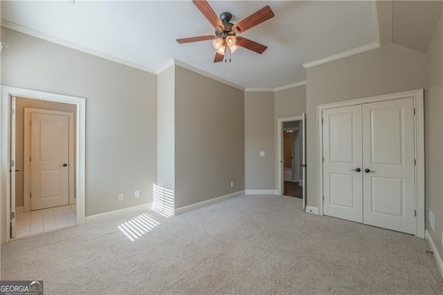 6186 Talmadge Run NW, Acworth, GA 30101 - unfurnished bedroom with carpet floors, a closet, ornamental molding, a ceiling fan, and lofted ceiling