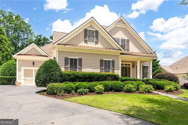 6186 Talmadge Run NW, Acworth, GA 30101 - craftsman-style home featuring board and batten siding, a front lawn, a garage, and driveway