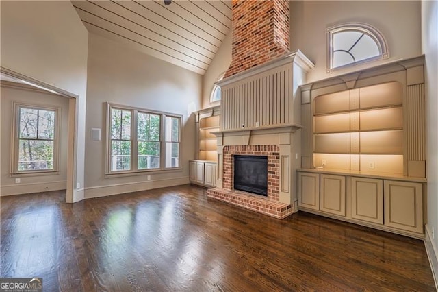 6186 Talmadge Run NW, Acworth, GA 30101 - unfurnished living room featuring high vaulted ceiling, dark wood-style flooring, a brick fireplace, and wooden ceiling