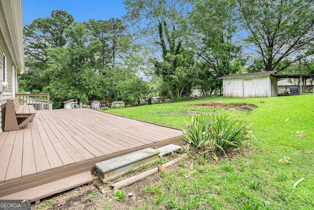2621 Walton Way SW, Marietta, GA 30060 - wooden terrace featuring a lawn, an outdoor structure, and view of scattered trees