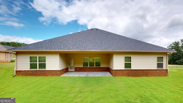 458 Southern Oaks Dr, Macon, GA 31216 - back of property with brick siding, a patio area, roof with shingles, and a yard