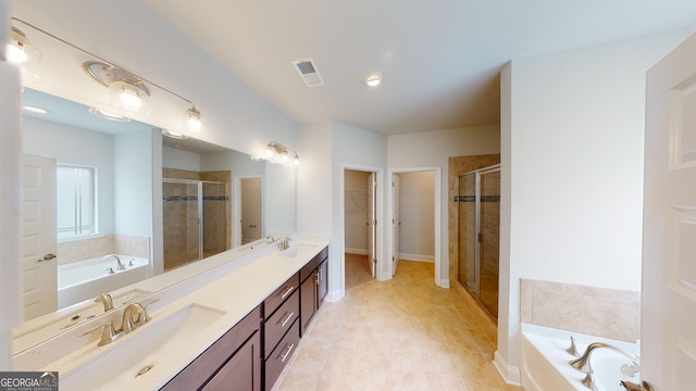 458 Southern Oaks Dr, Macon, GA 31216 - full bath featuring a stall shower, double vanity, a garden tub, a walk in closet, and tile patterned floors