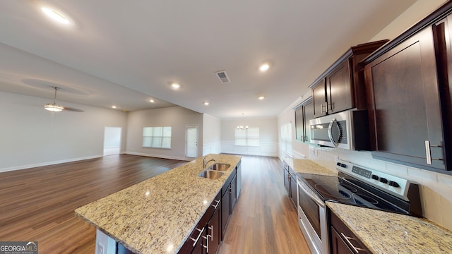 458 Southern Oaks Dr, Macon, GA 31216 - kitchen featuring stainless steel appliances, dark wood finished floors, a kitchen island with sink, tasteful backsplash, and recessed lighting