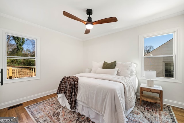 1891 W Forrest Ave, Atlanta, GA 30344 - bedroom with multiple windows, ornamental molding, wood finished floors, and a ceiling fan