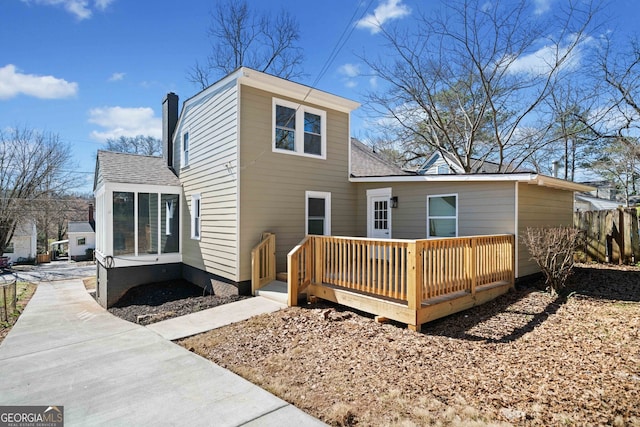 1891 W Forrest Ave, Atlanta, GA 30344 - rear view of house featuring a wooden deck, a shingled roof, and a chimney