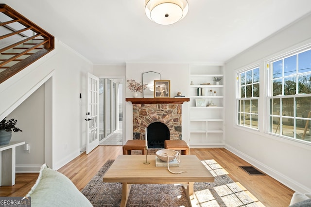1891 W Forrest Ave, Atlanta, GA 30344 - living room featuring a fireplace, light wood-style floors, built in features, and french doors