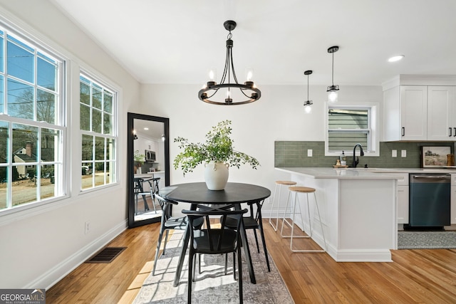 1891 W Forrest Ave, Atlanta, GA 30344 - dining area featuring light wood-style floors, a chandelier, and recessed lighting