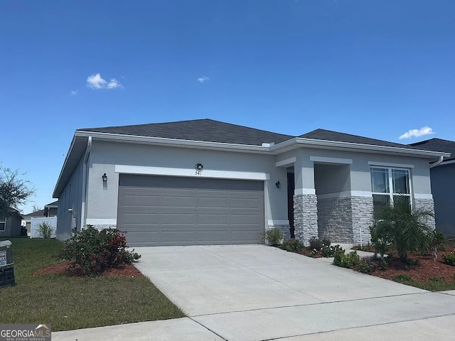 541 Buchannan Dr, Davenport, FL 33837 - view of front of home featuring stucco siding, stone siding, a garage, driveway, and a front lawn